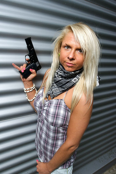 File:Blonde woman with a plastic gun.jpg